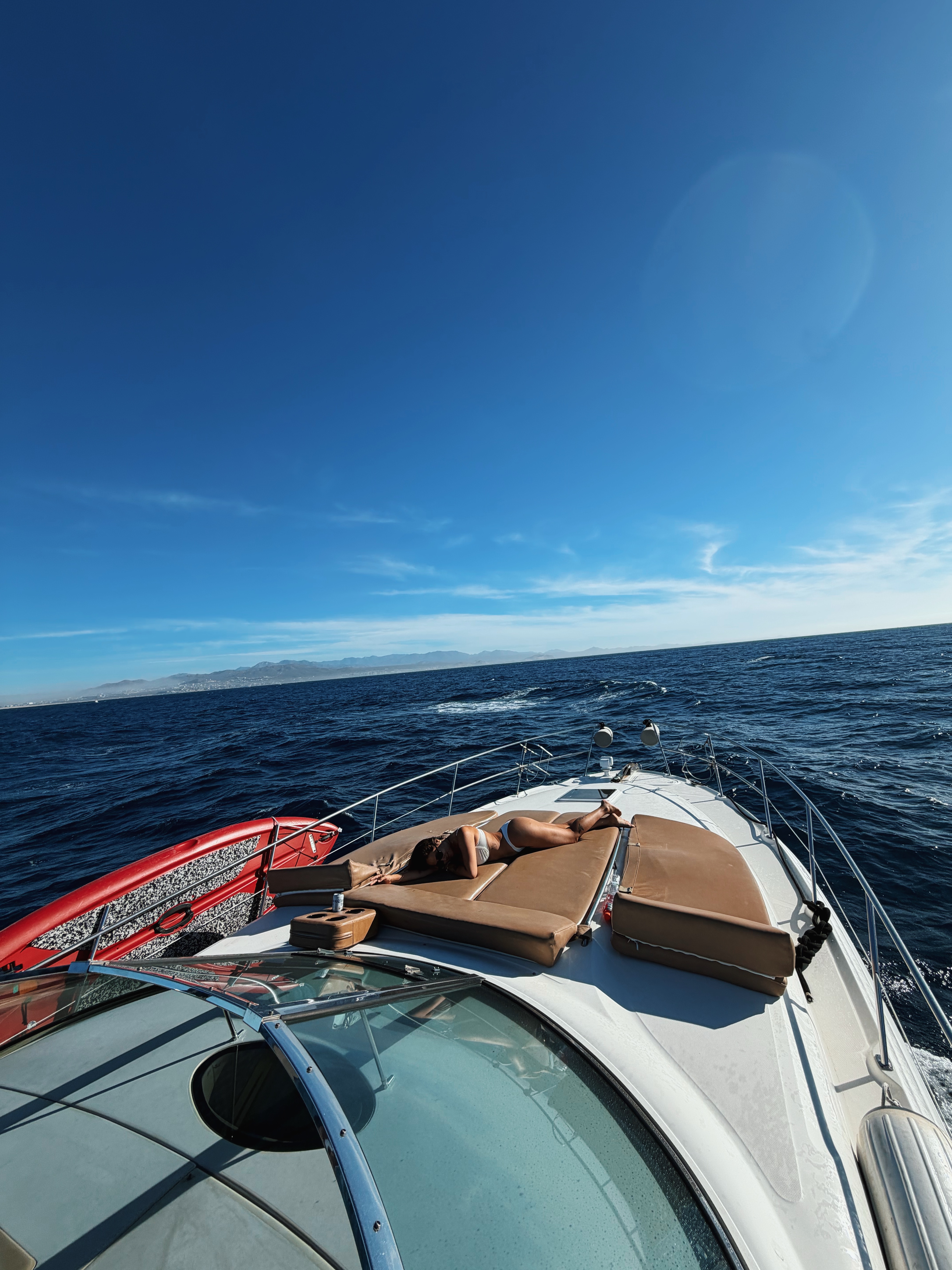 Private yacht cruising along the Cabo coastline