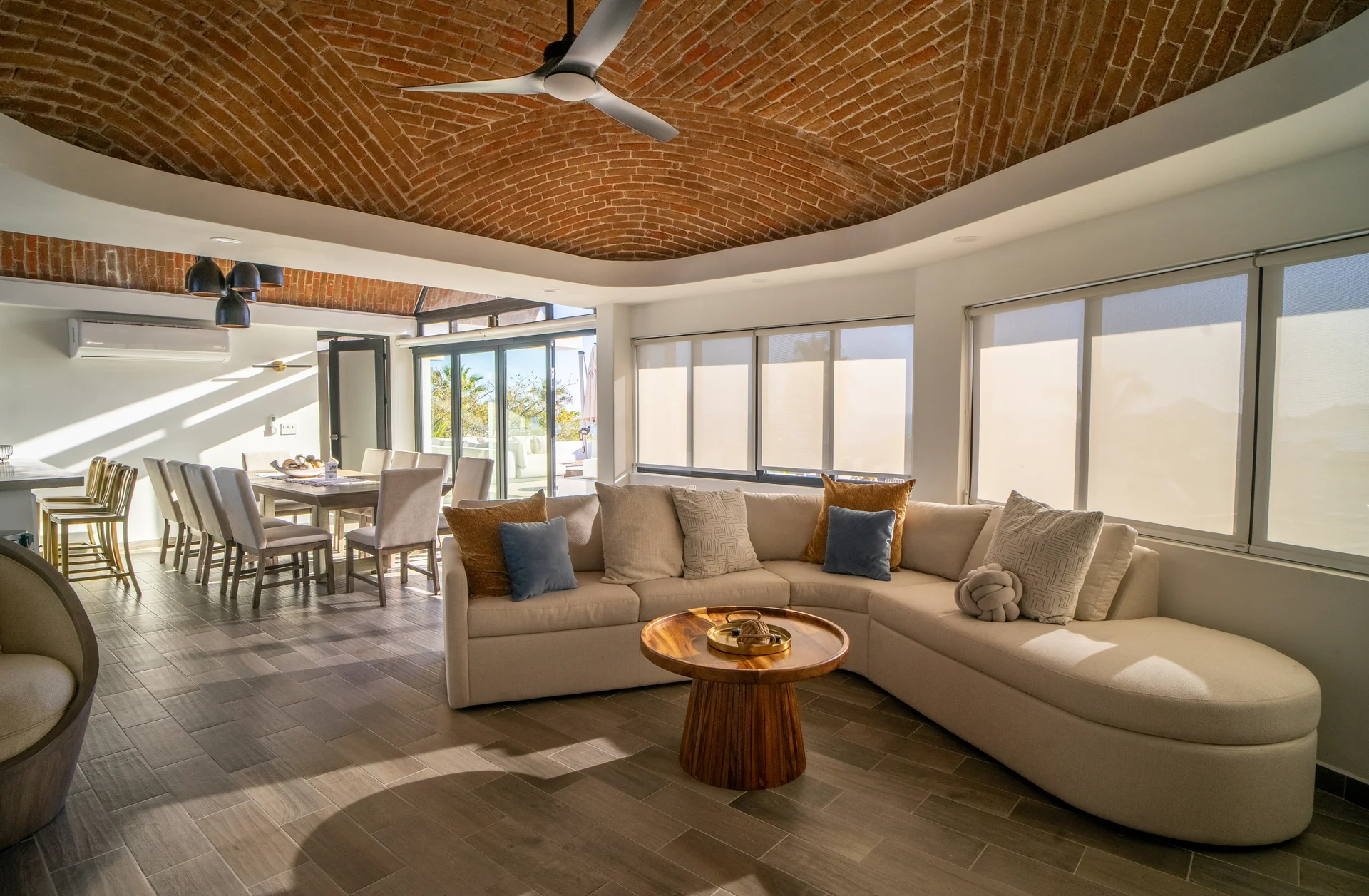 Villa living room with curved sofa and brick ceiling